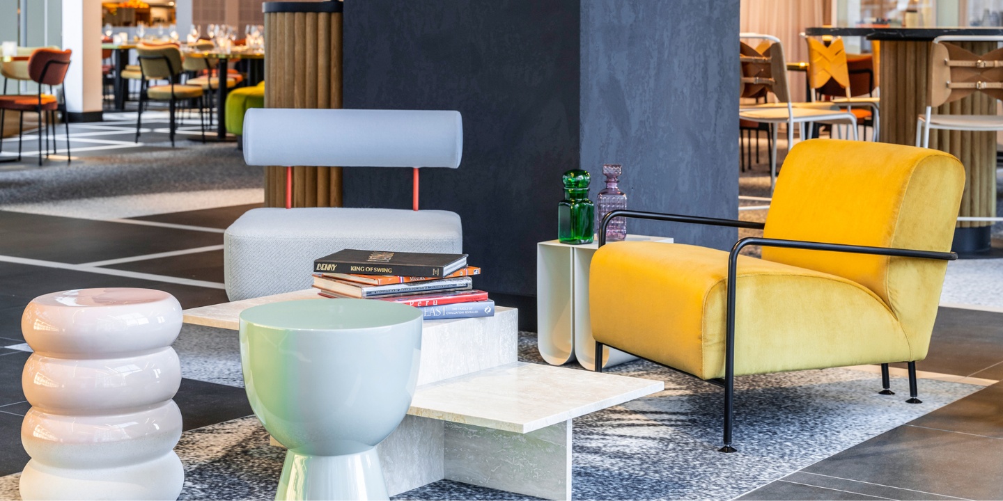 Two lounge chairs and a coffeetable in the lobby of TRIBE Amsterdam
