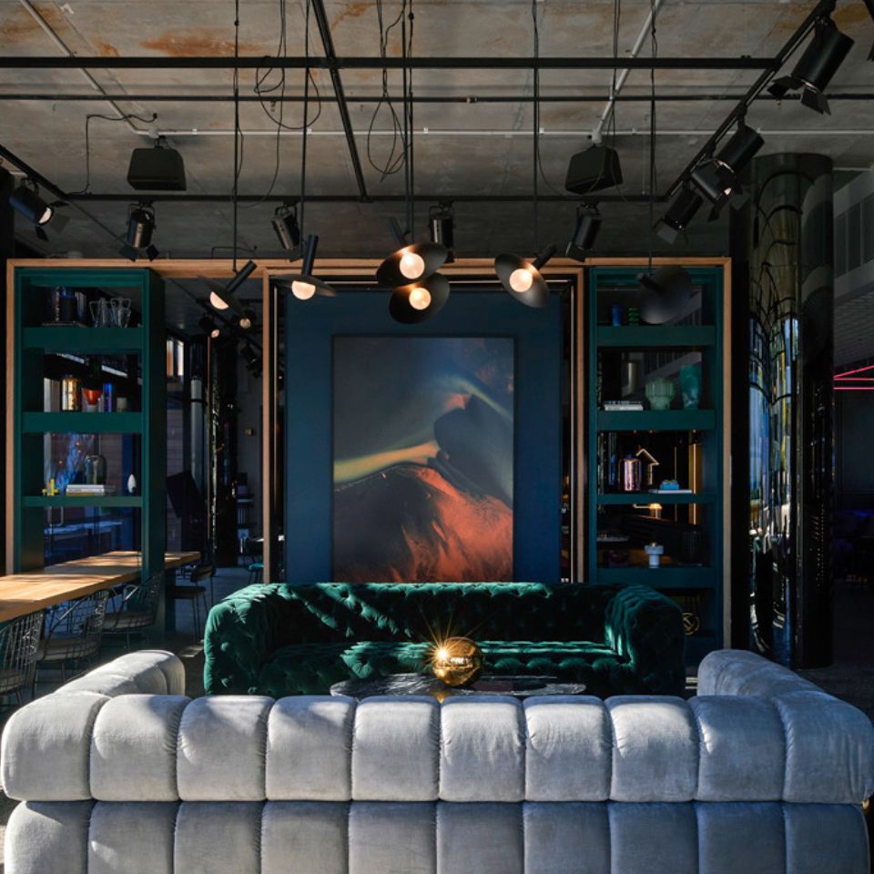 Two couches facing each other, in the background is a shelf with decoration on it.