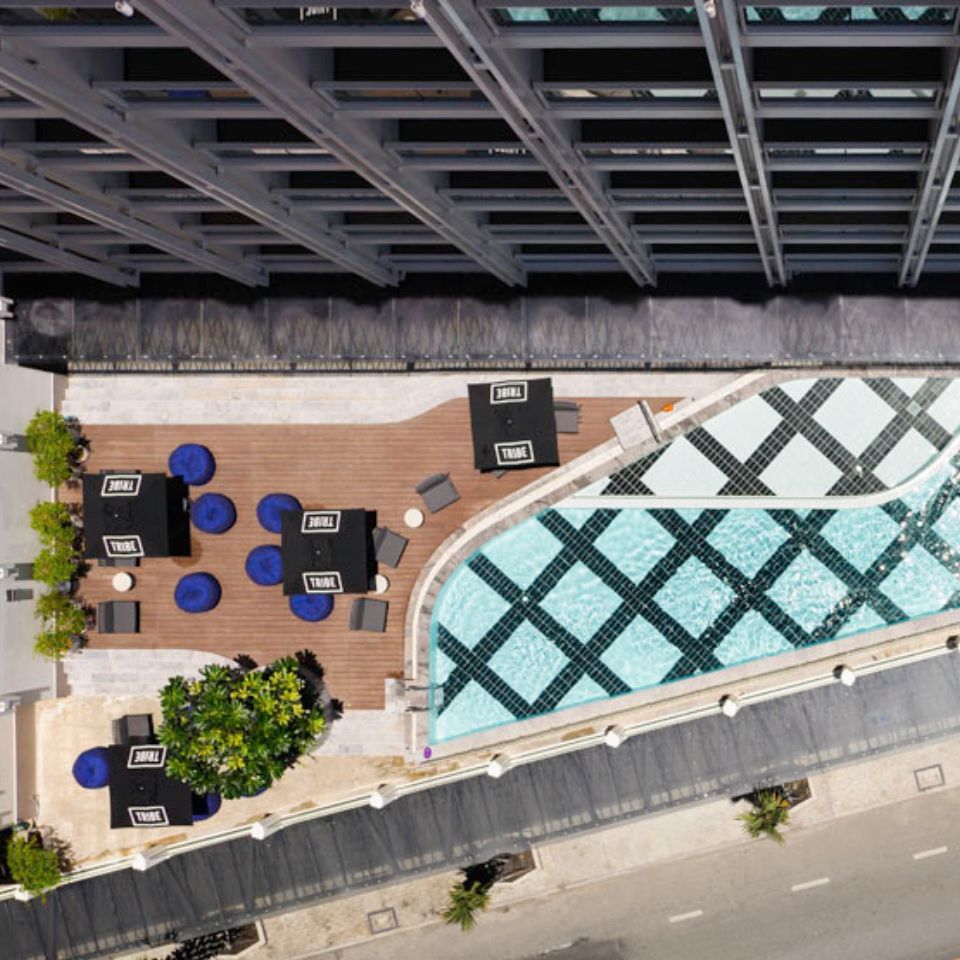 Aerial view of the pool, with lounge chairs on the pool deck next to it.