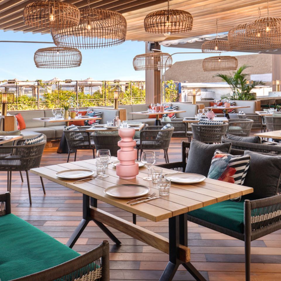 the outdoor terrace at Afterglow Restaurant with several laid tables and seating ares