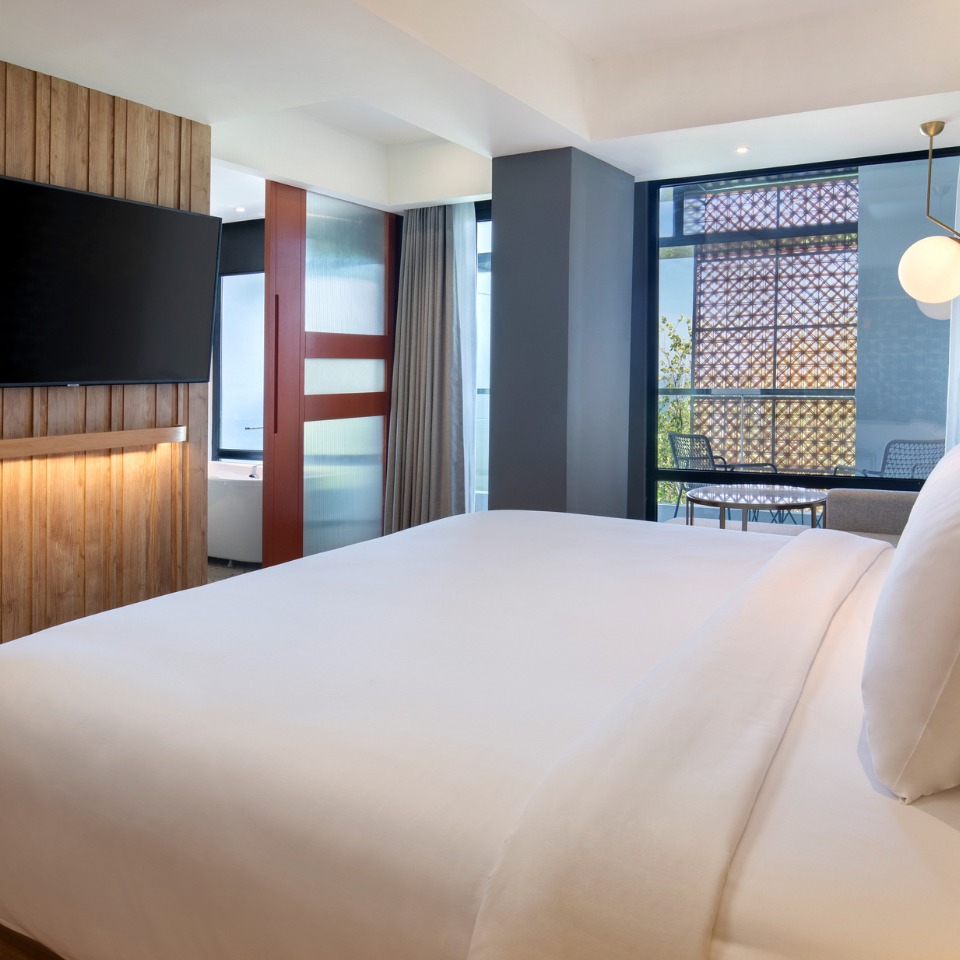 A double bed with white linen