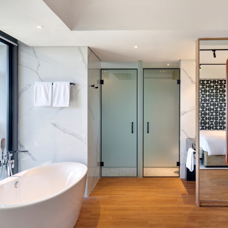View from the hotel room towards the bathroom, with a bathtub in the room