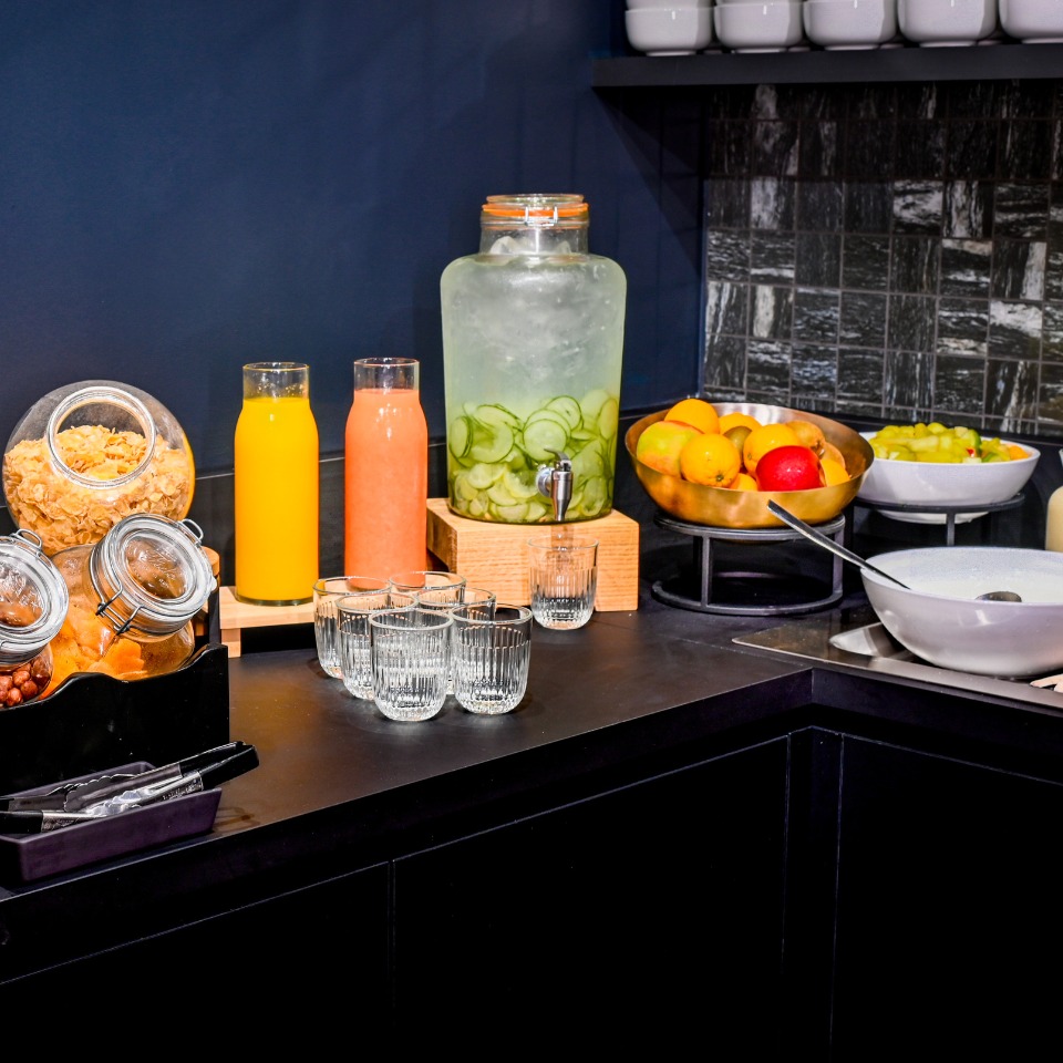 Breakfast set up at TRIBE Table. There are several fresh juices, cereal and fruit.