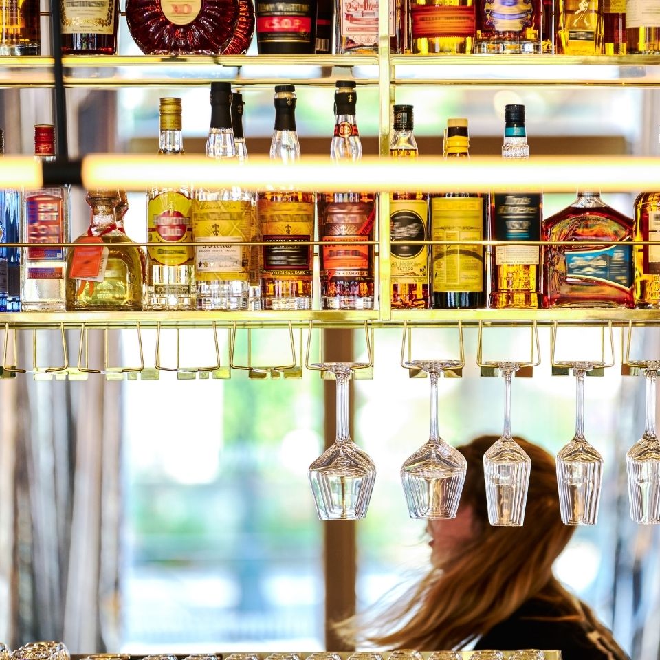 Bottles and hanging glasses behind the bar.