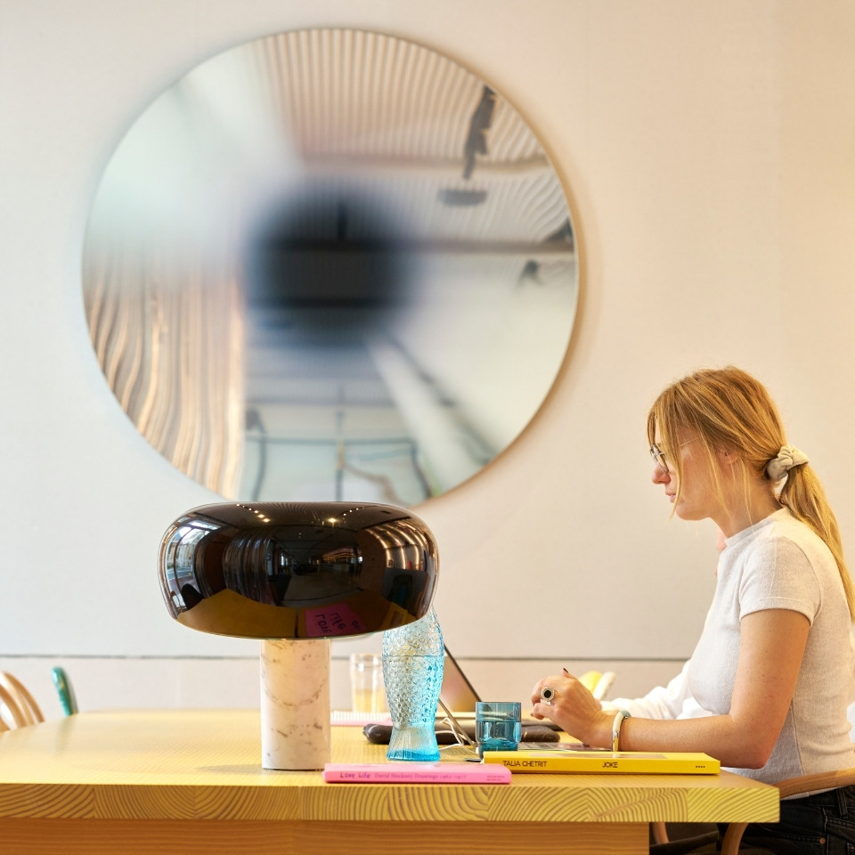 A guest working on a laptop at a lounge table.