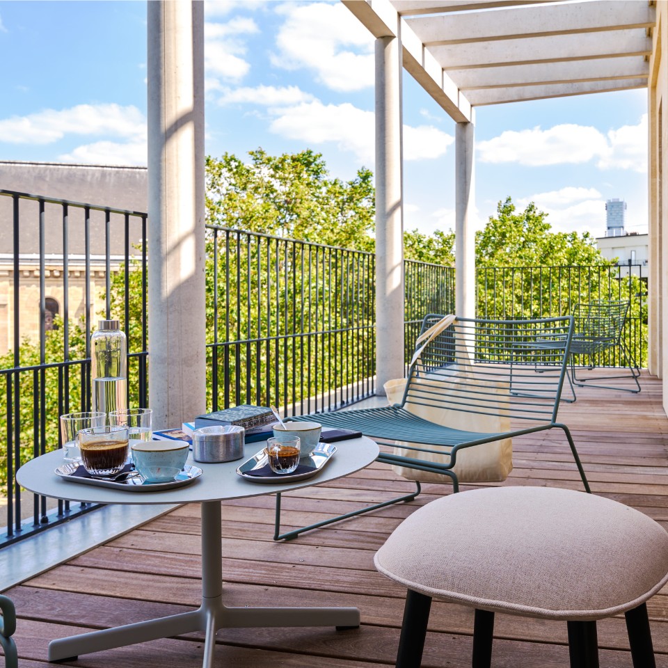 Furnished terrace with a lounger and coffee on the table.