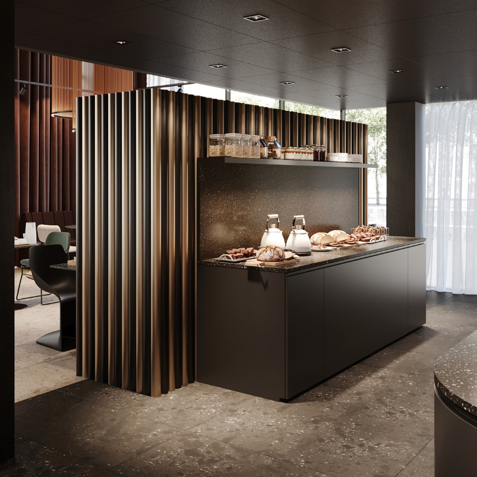 Comptoir de cuisine avec pâtisseries, bocaux et luminaires derrière une paroi décorative.