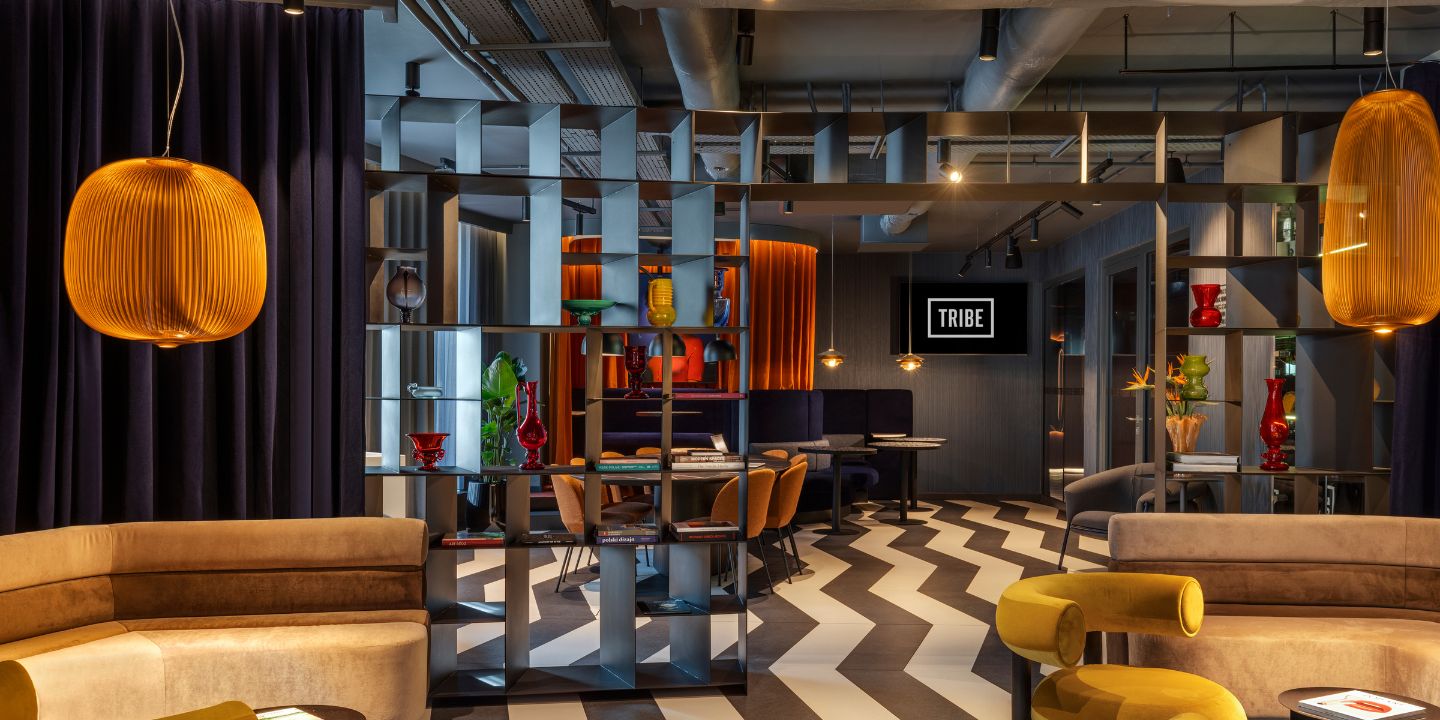 Chic interior of a modern lounge, featuring stylish furniture, vibrant decor, and decorative lighting in a trendy setting.