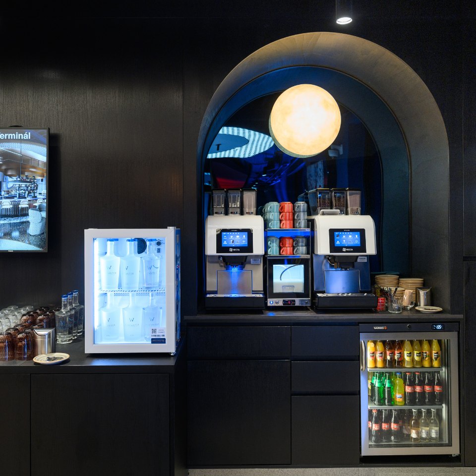Coffee machines and a drinks refrigerator in a refreshment alcove.