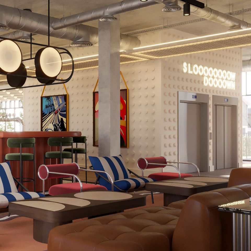 Living area with striped lounge chairs, red armchairs, brown leather sofa, wooden tables, and two elevators in the background