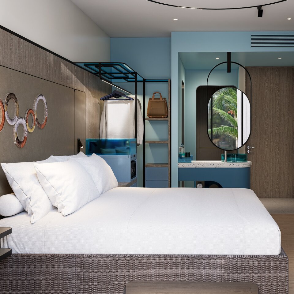 Contemporary hotel room interior looking across a plush king-size bed toward a walk-in wardrobe hanger rack and open vanity station.