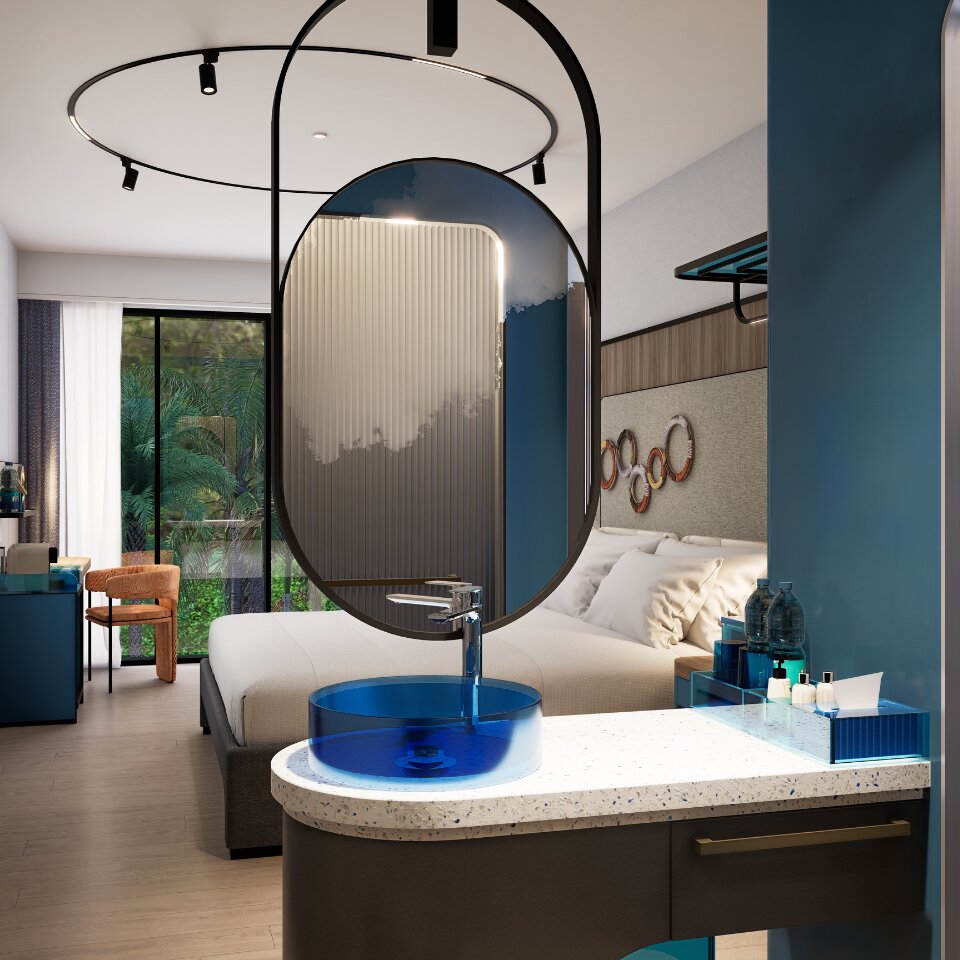 Boutique hotel king bedroom showcasing an open-concept washbasin vanity with a blue glass vessel sink and round suspended mirror.
