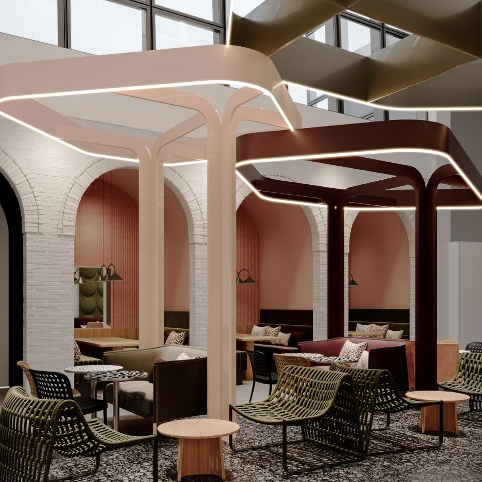 Sculptural ribbons hang above a lounge beneath a glass roof.