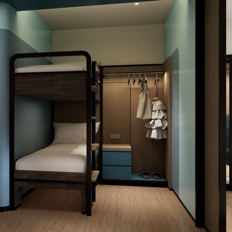 Compact hotel family suite with custom wooden bunk beds, built-in wardrobe, and minimalist blue-accented nightstand.