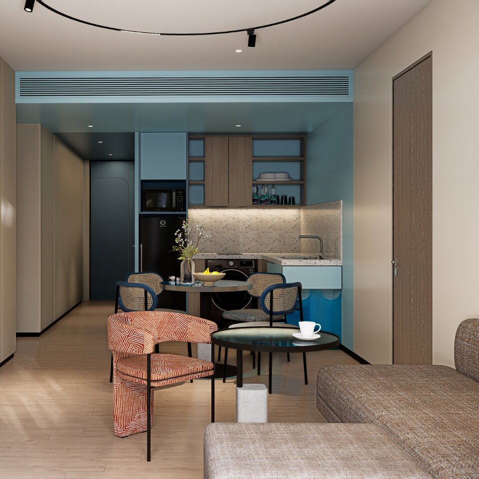 Sleek hotel suite kitchenette and dining area featuring retro-patterned armchairs, dining table, microwave, and integrated laundry machine.