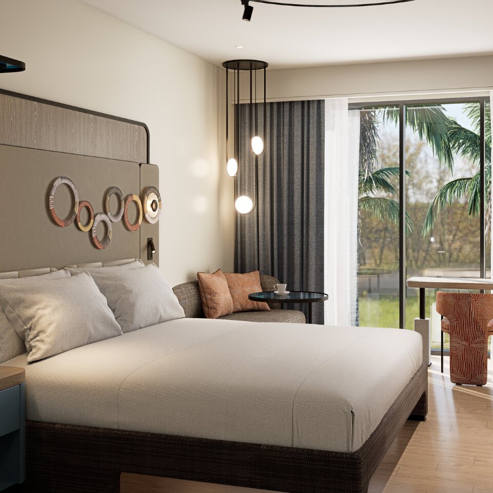 Bright hotel bedroom with a king-sized bed, wall-mounted ring art, cozy seating corner, and sliding glass doors opening to tropical palm trees.
